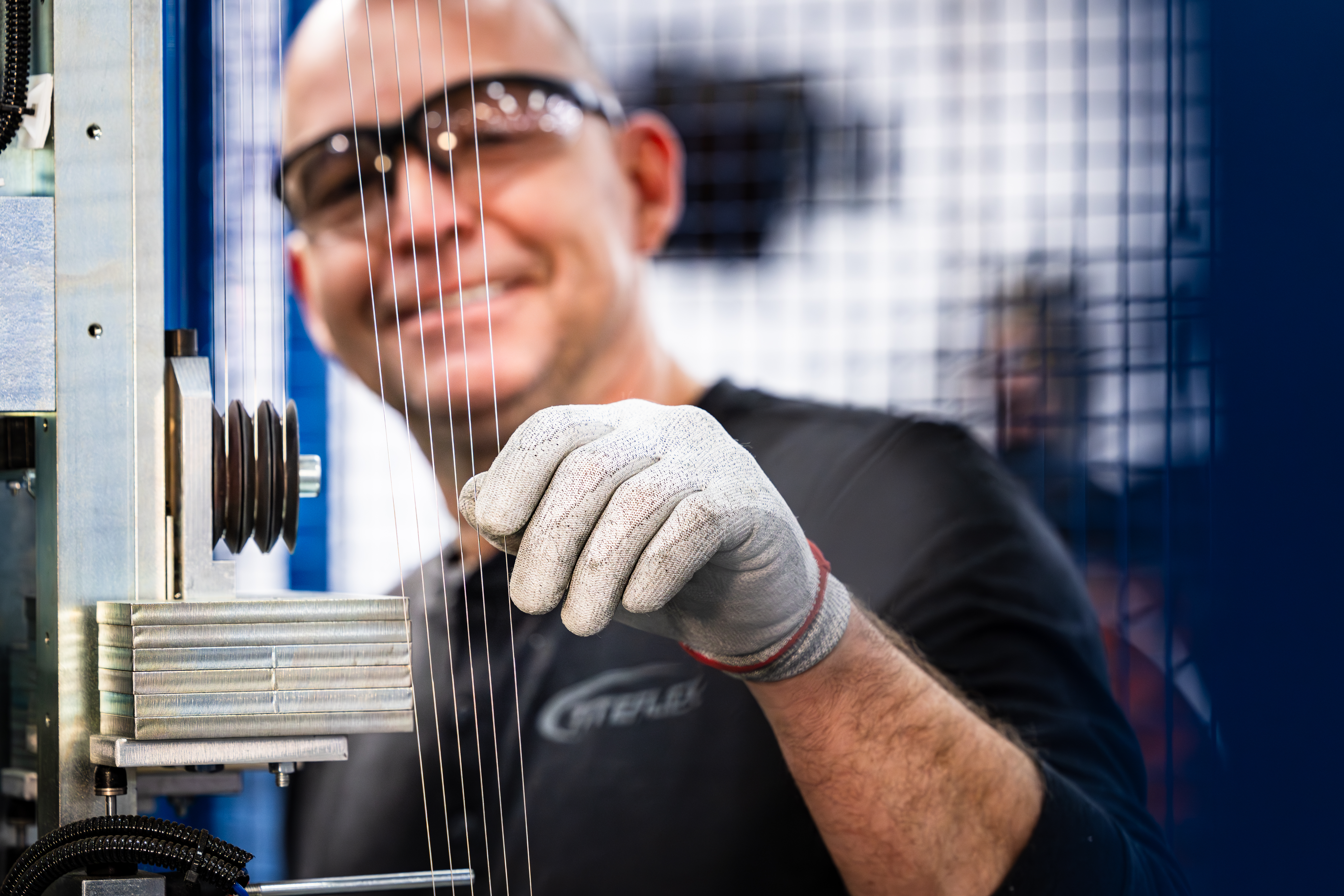 Man Smiling At Work Wearing Safety Glasses And Gloves