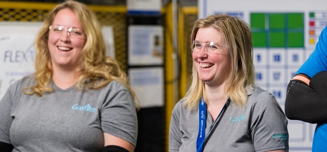 Two Females Smiling With Goggles