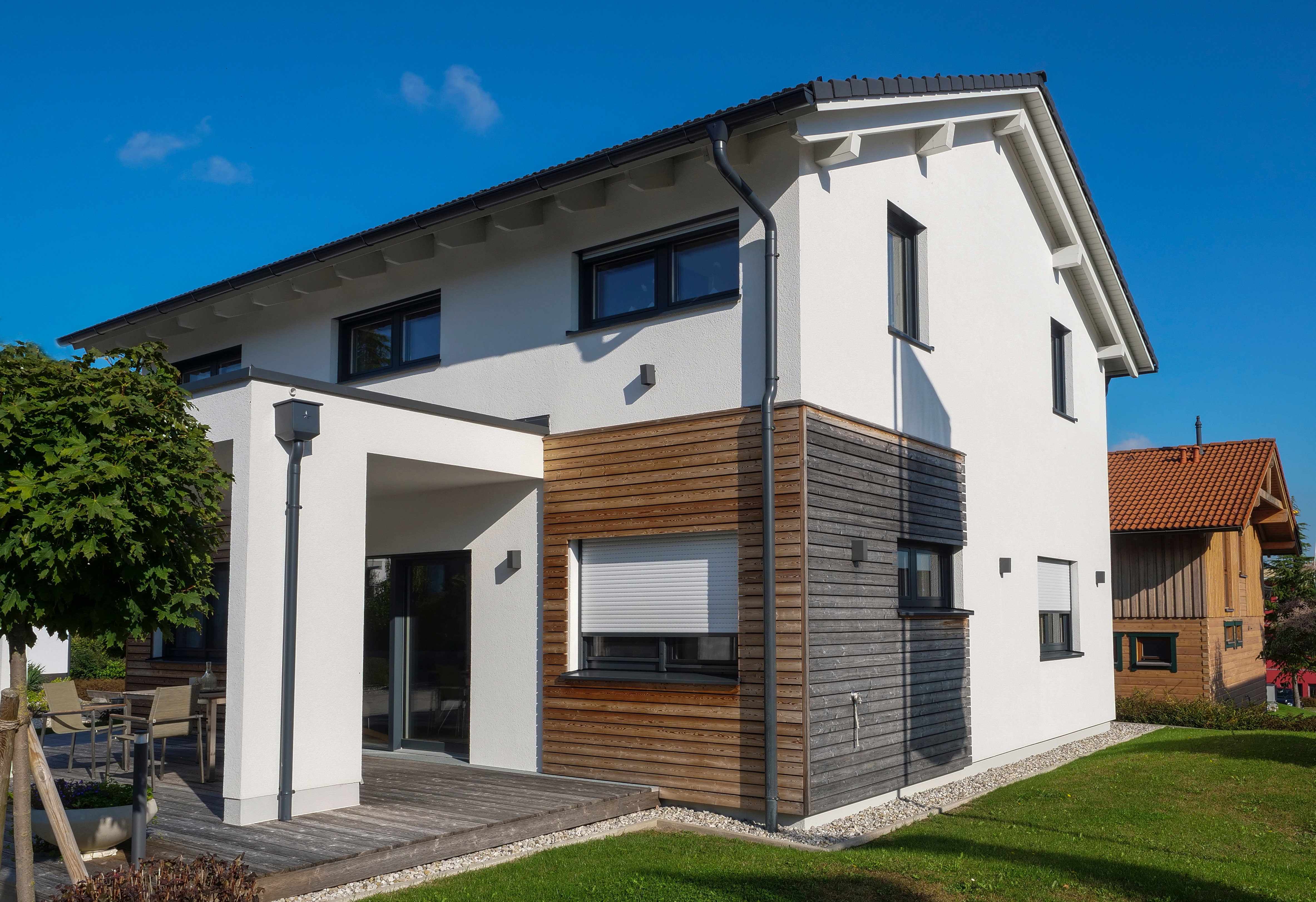House With White Walls And Wooden Cladding