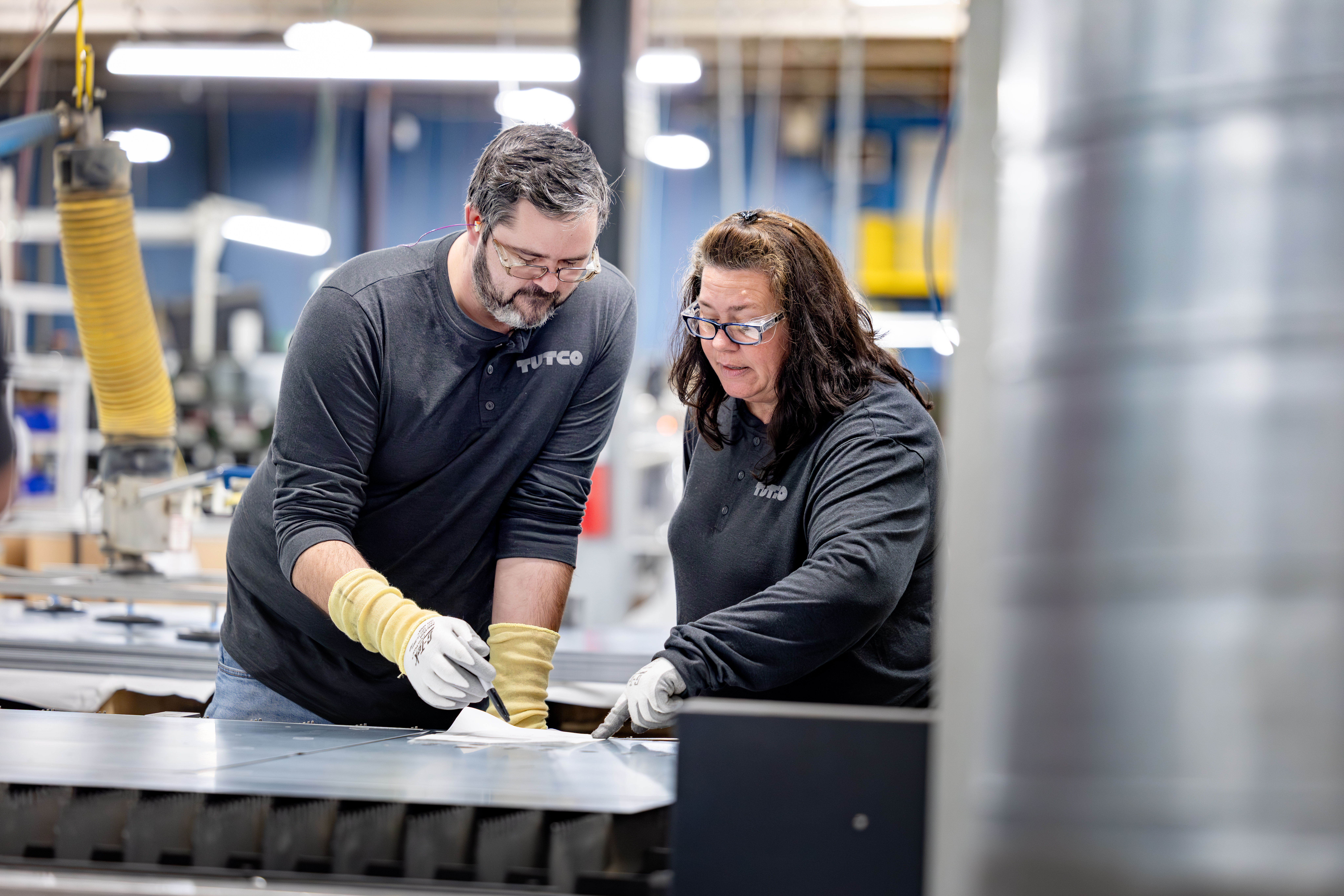 Tutco Workers Looking At Paper