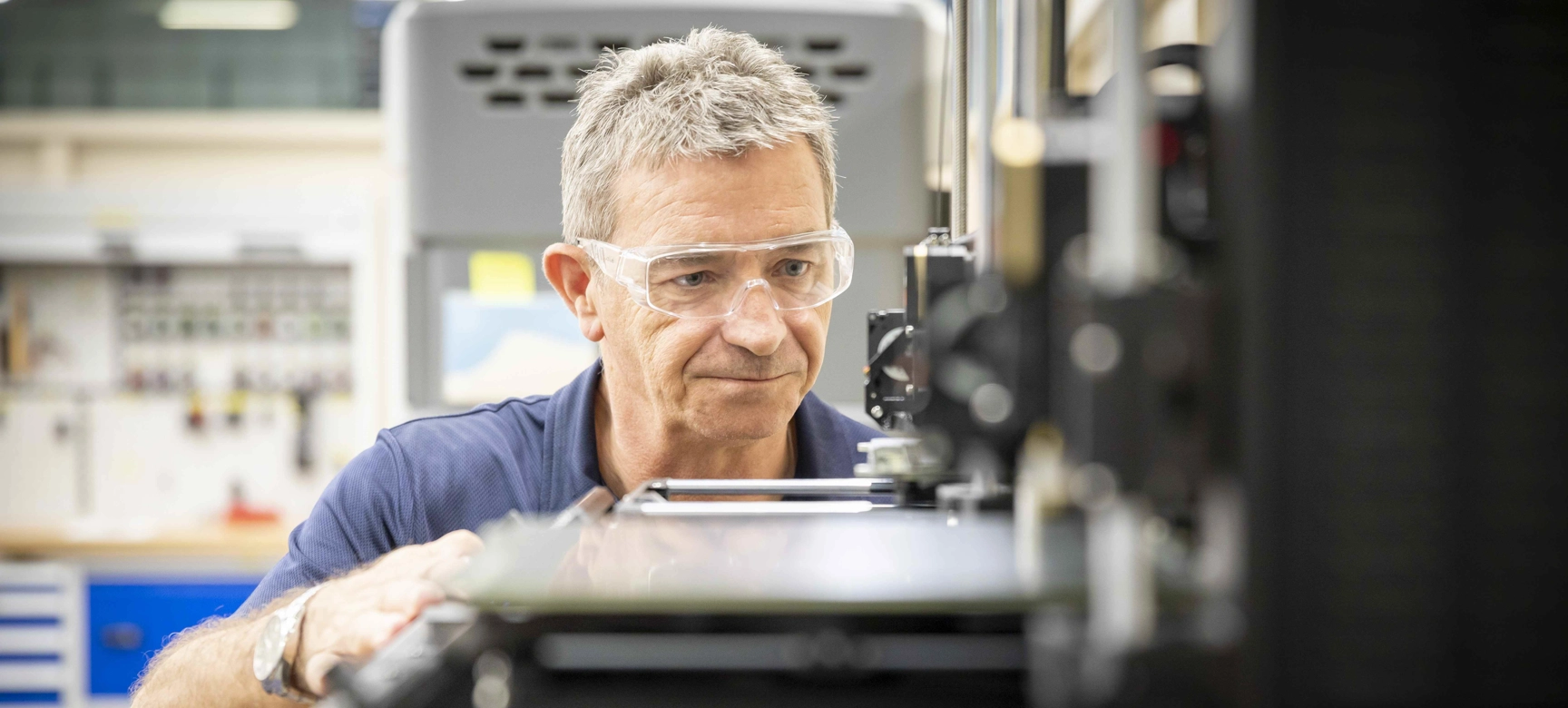 Engineer With Grey Hair Operating Machinery