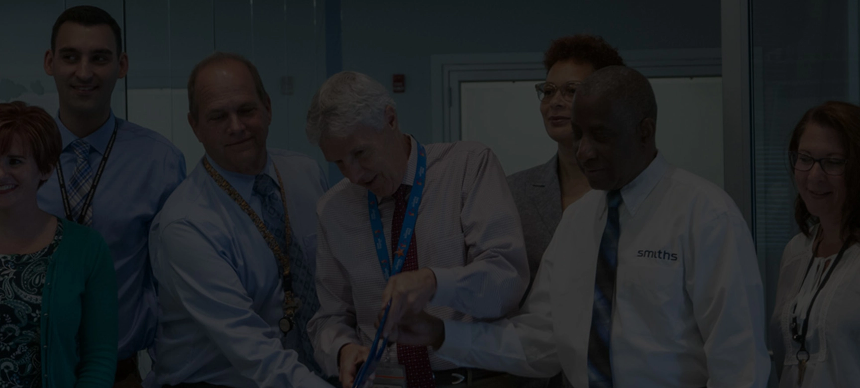 People at the cutting of a ribbon