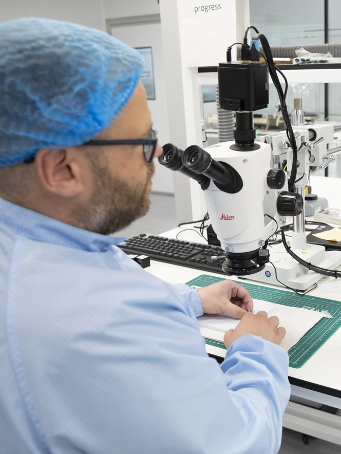 Employee In Dundee Lab Looking Through Microscope